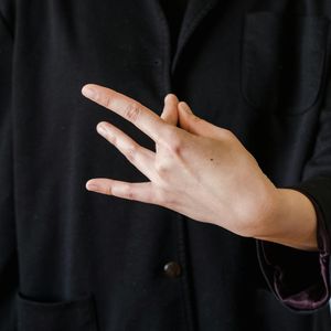 Close-up of hands in a meditative mudra gesture.